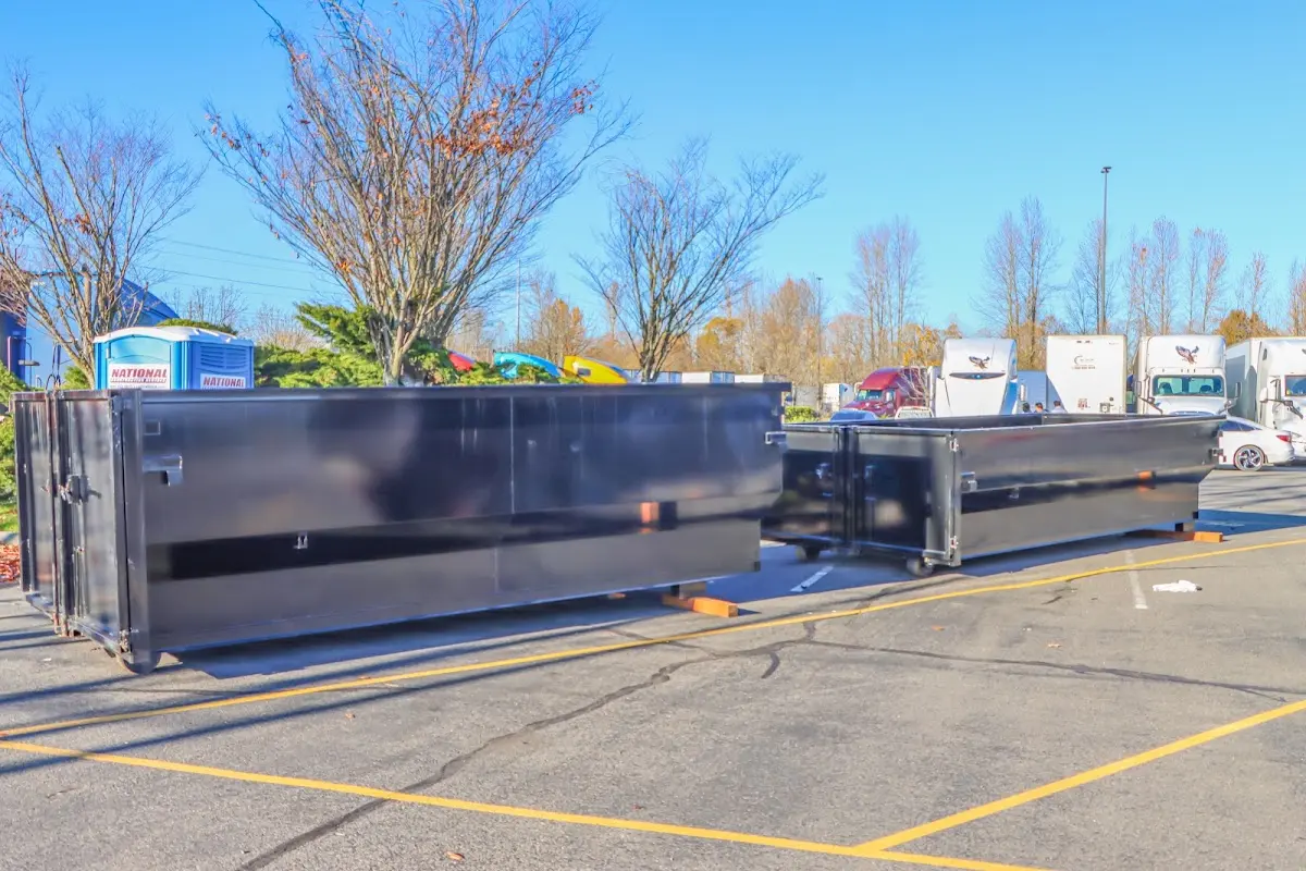 Professional dumpster rental service with roll-off container on residential driveway in Unity